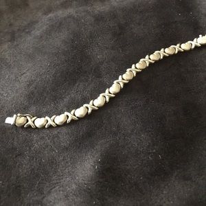 Gold bracelet with X’s and hearts